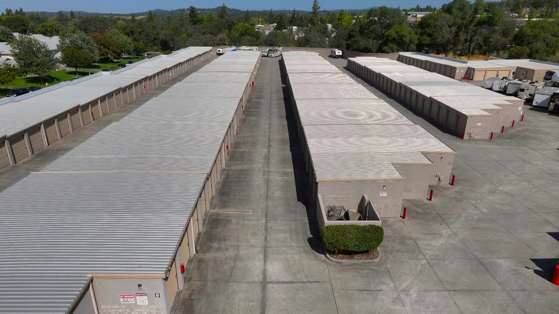 Elevated view down the wide drive between two long unit buildings at Rock Creek Self Storage
