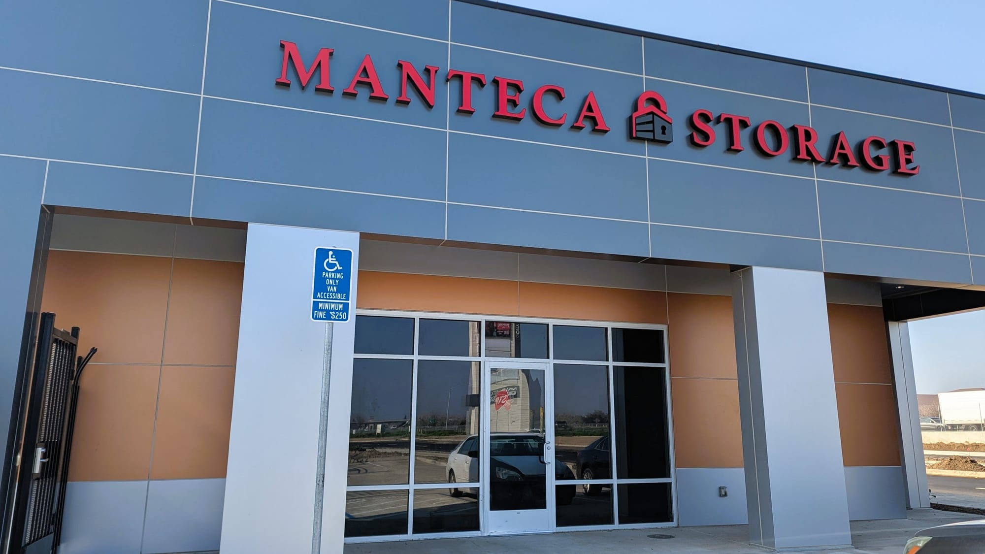 MANTECA STORAGE lettering above the glass office entrance in Manteca, CA