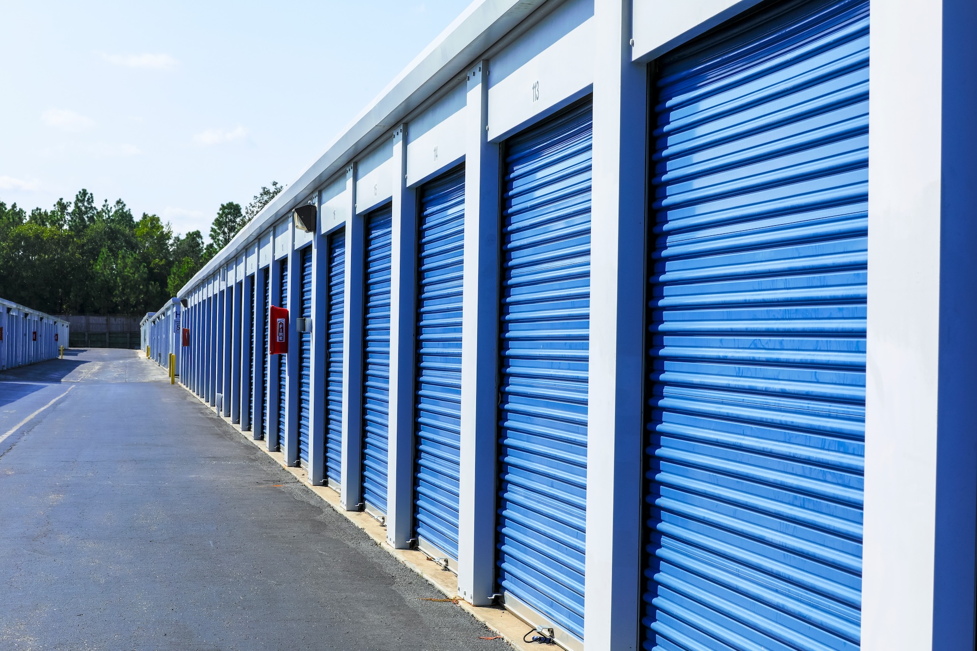 Long row of blue roll-up doors at Greenville Easy Storage in Greenville, MS