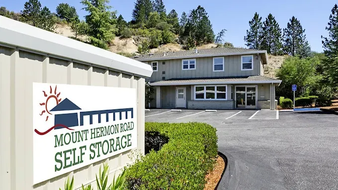 Mount Hermon Road Self Storage's office and roadside sign in Scotts Valley, CA, below wooded hills