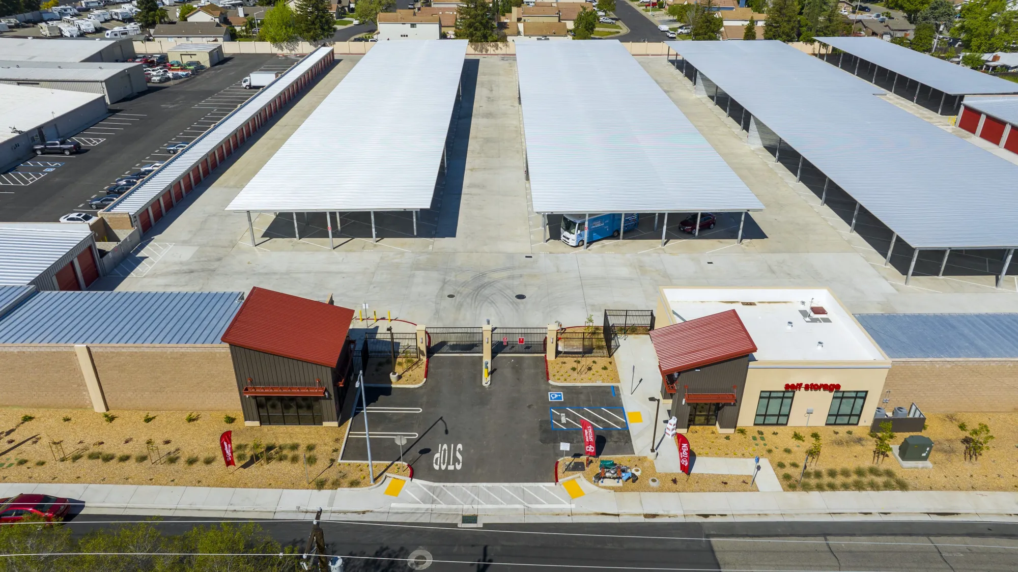 Aerial view of RoadRunner RV Storage in Roseville, CA: covered RV canopies and drive-up units